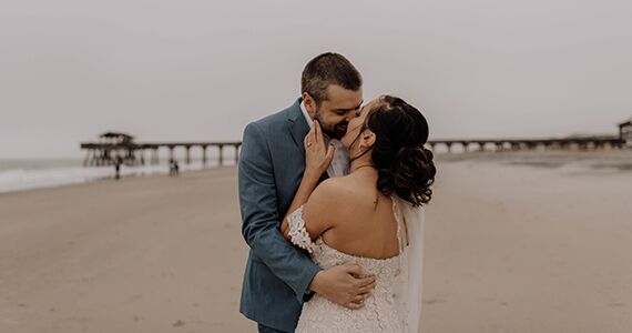 A couple kissing after their elopement on a beach in Georgia.